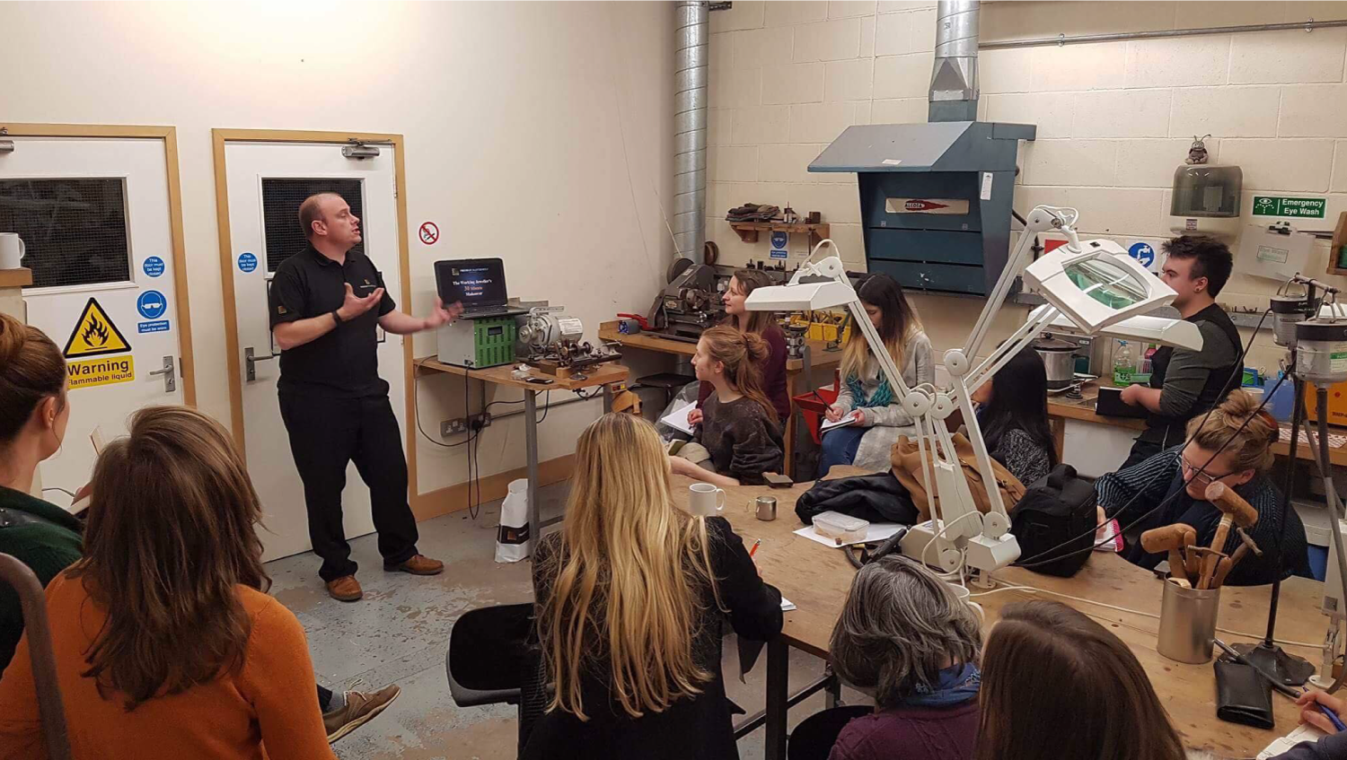 Man talking to jewellery students about jewellery reclamation