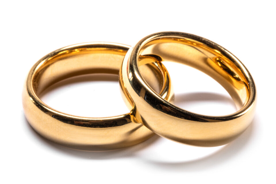 Couple of gold wedding rings isolated on white background